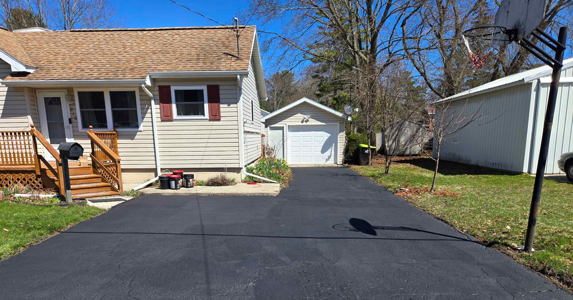 Freshly seal coated asphalt driveway in Northern Michigan